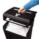 A person using a Powershred® P-48C Cross-Cut Shredder to shred paper.